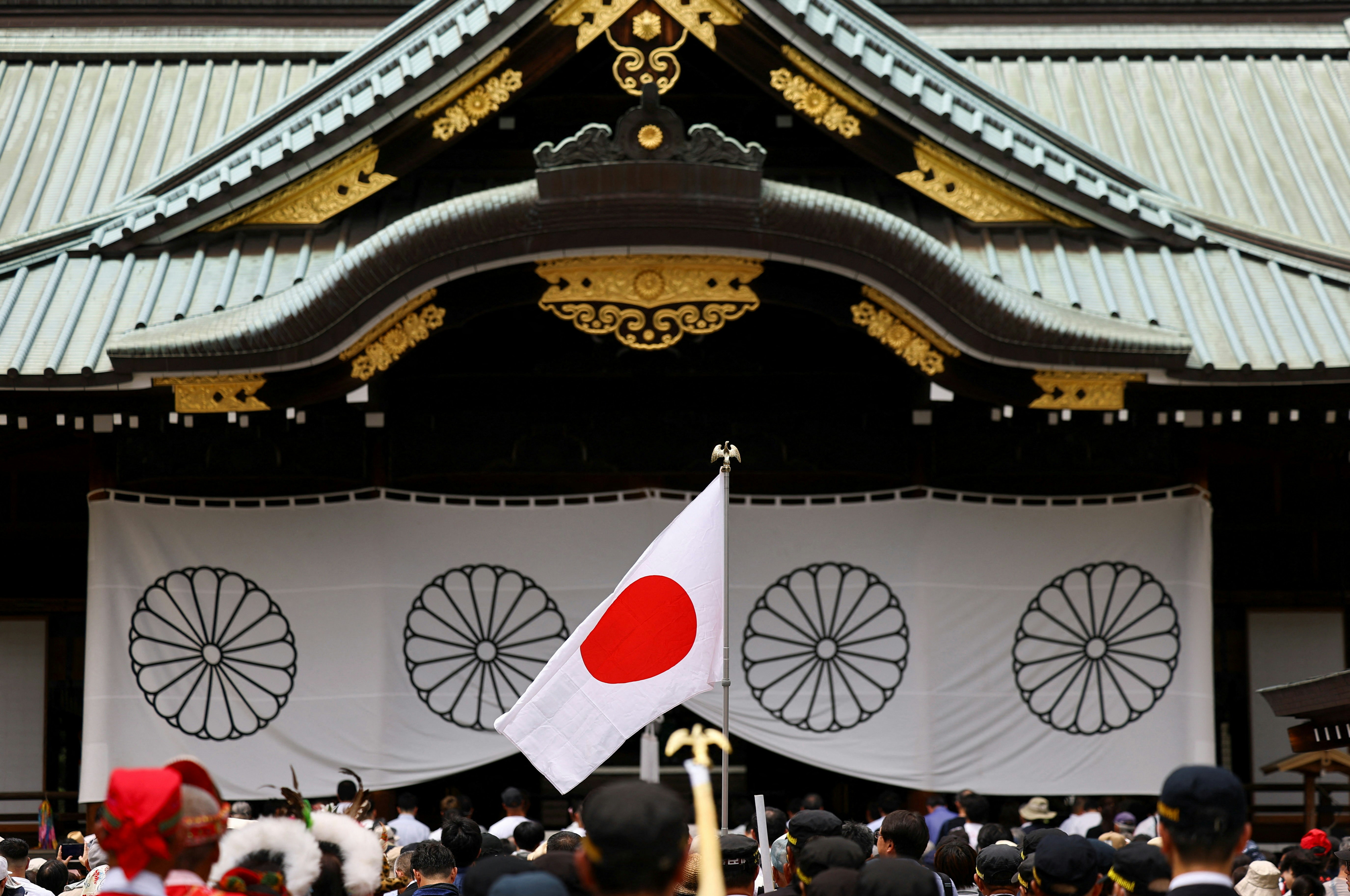2026年8月15日,日本东京,一面日本国旗迎风飘扬,民众前往靖国神社祭拜二战死难者,纪念日本在二战中投降81周年。(Reuters)