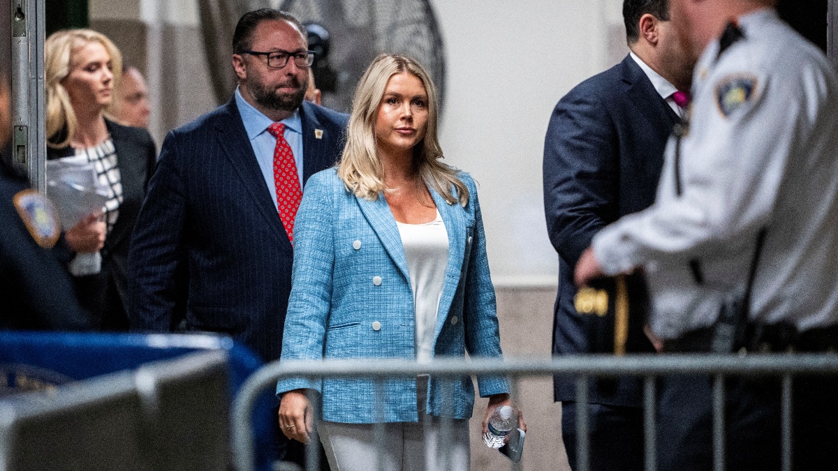 Karoline Leavitt, Spokeswoman for former U.S. President Donald Trump walks into the courtroom behind Trump as she attends the Trump criminal trial at the New York State Supreme Court in New York, New York, Wednesday, May, 29, 2024. At left is Trump advisor, Jason Miller. Doug Mills/Pool via REUTERS