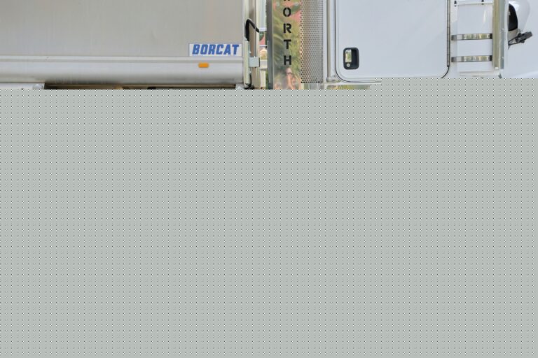A white semi truck parked on the side of the road