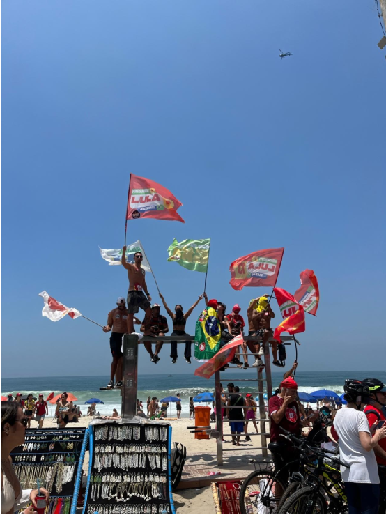 10月23日，卢拉在里约热内卢科帕卡巴纳海滩举行集会，支持者在海滩旁挥舞旗帜。（摄影：杨小宇）